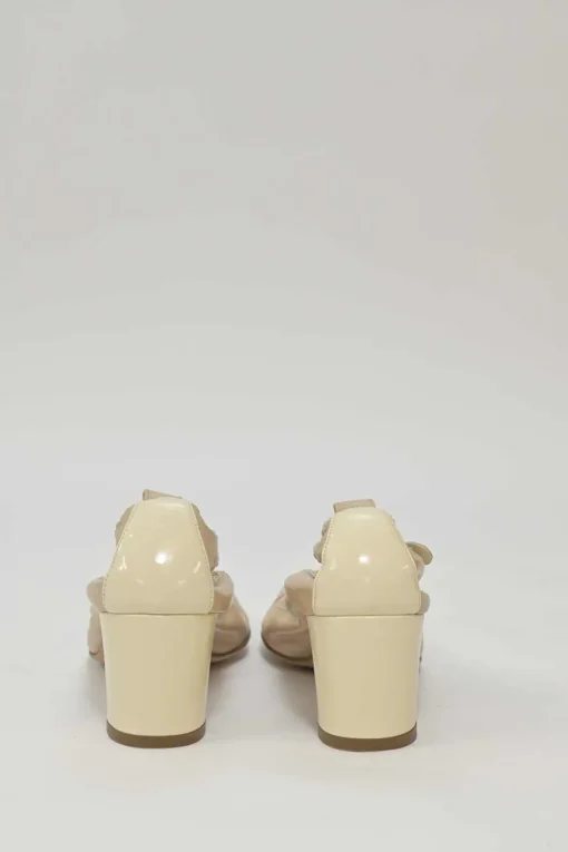 Beige and ivory lambskin low-heel Spirit pumps with contrast cap toe
