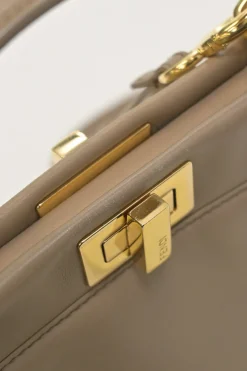 Beige leather Peekaboo satchel with gold-tone metallic hardware and adjustable shoulder strap