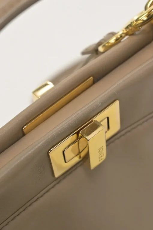 Beige leather Peekaboo satchel with gold-tone metallic hardware and adjustable shoulder strap