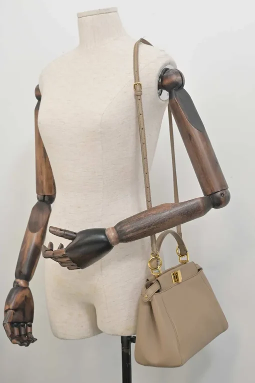 Beige leather Peekaboo satchel with gold-tone metallic hardware and adjustable shoulder strap