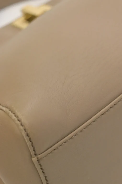 Beige leather Peekaboo satchel with gold-tone metallic hardware and adjustable shoulder strap