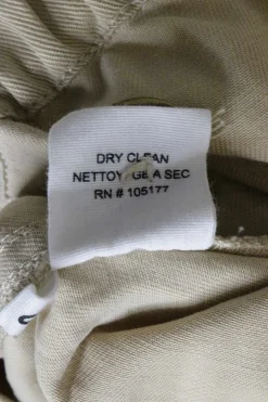Beige linen twill pull-on button-front paperbag waist tapered leg trousers with slanted hip pockets
