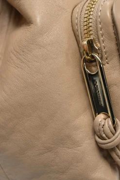 Beige studded leather convertible backpack with zip straps