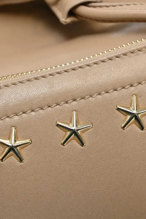 Beige studded leather convertible backpack with zip straps
