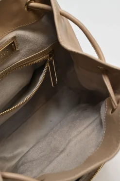 Beige studded leather convertible backpack with zip straps