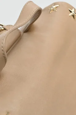 Beige studded leather convertible backpack with zip straps