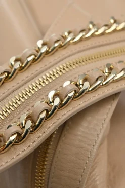Beige studded leather convertible backpack with zip straps