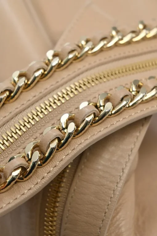 Beige studded leather convertible backpack with zip straps