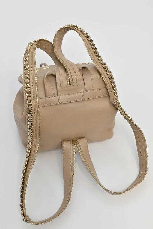 Beige studded leather convertible backpack with zip straps