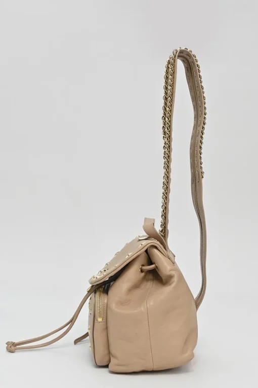 Beige studded leather convertible backpack with zip straps