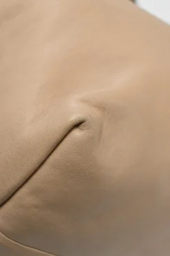 Beige studded leather convertible backpack with zip straps