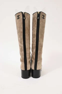 Beige suede lace-up tall boots with contrasting cap toe