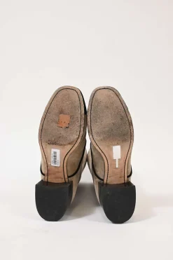 Beige suede lace-up tall boots with contrasting cap toe