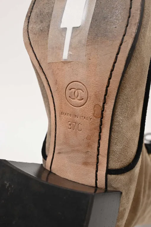 Beige suede lace-up tall boots with contrasting cap toe