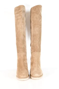Beige suede lug-sole pull-on knee-high wedge boots with gold-tone metallic chain trim