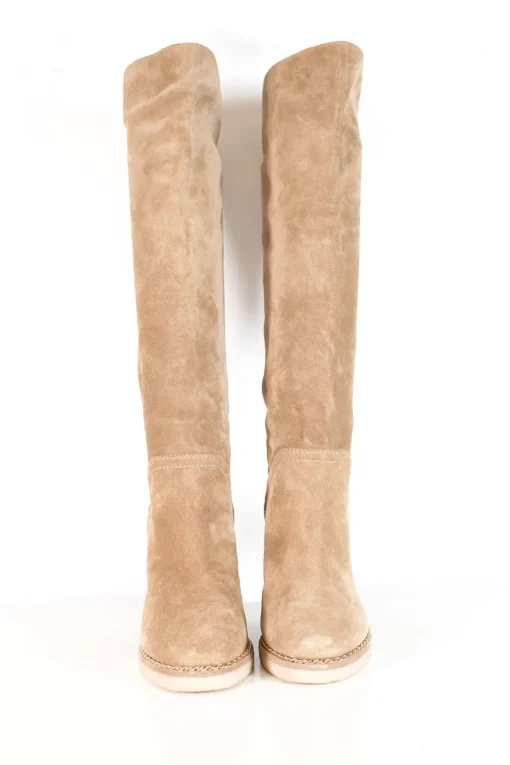 Beige suede lug-sole pull-on knee-high wedge boots with gold-tone metallic chain trim