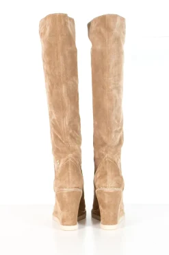 Beige suede lug-sole pull-on knee-high wedge boots with gold-tone metallic chain trim
