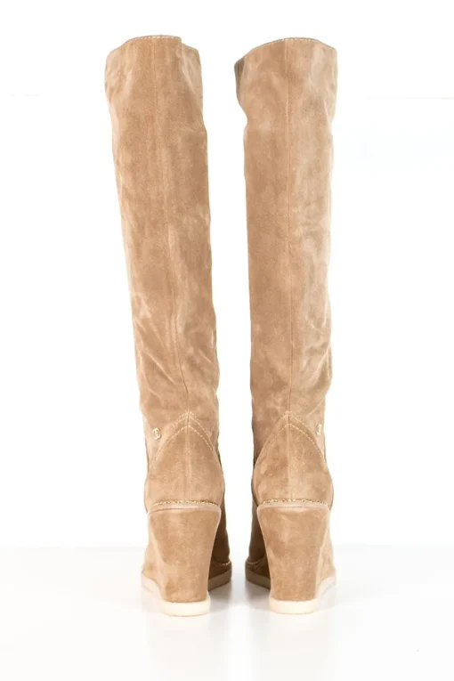 Beige suede lug-sole pull-on knee-high wedge boots with gold-tone metallic chain trim
