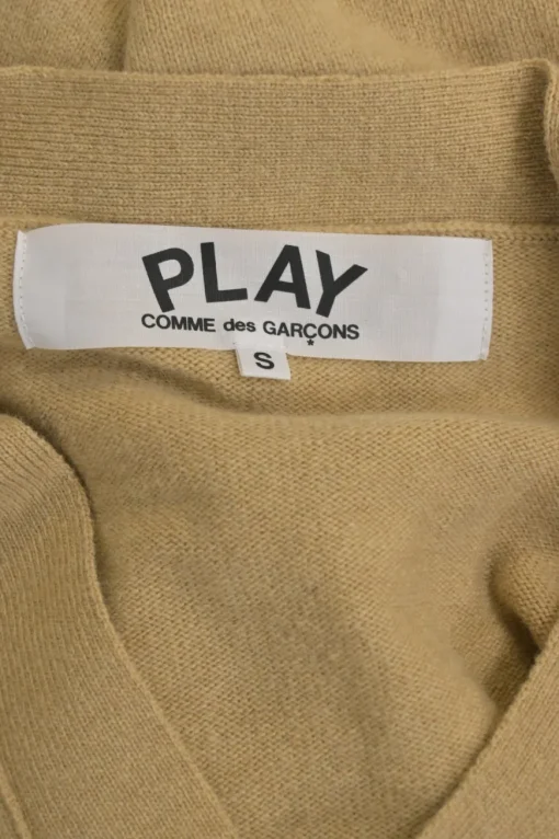 Beige wool button-front cardigan featuring signature chest heart broderie motif