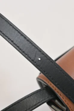 Black and brown leather Heel Duo anagram-embossed shoulder flap bag with adjustable shoulder strap