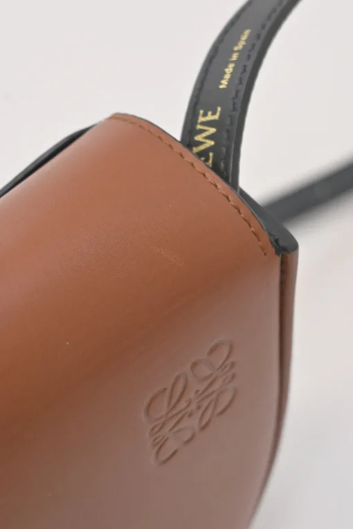 Black and brown leather Heel Duo anagram-embossed shoulder flap bag with adjustable shoulder strap