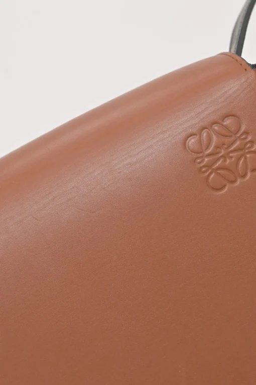 Black and brown leather Heel Duo anagram-embossed shoulder flap bag with adjustable shoulder strap