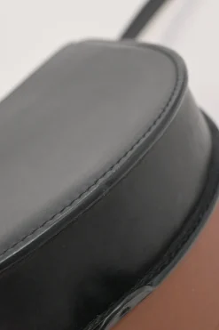 Black and brown leather Heel Duo anagram-embossed shoulder flap bag with adjustable shoulder strap