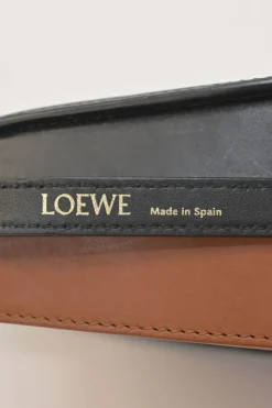 Black and brown leather Heel Duo anagram-embossed shoulder flap bag with adjustable shoulder strap