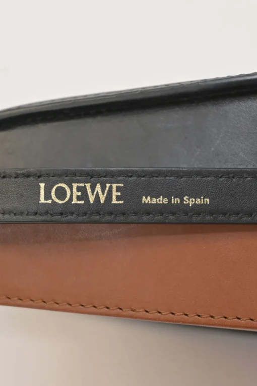 Black and brown leather Heel Duo anagram-embossed shoulder flap bag with adjustable shoulder strap