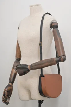 Black and brown leather Heel Duo anagram-embossed shoulder flap bag with adjustable shoulder strap