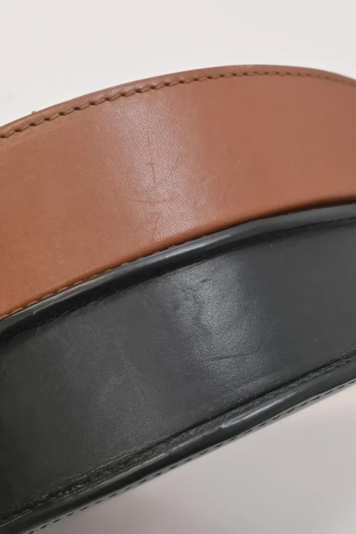 Black and brown leather Heel Duo anagram-embossed shoulder flap bag with adjustable shoulder strap