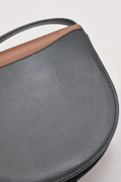 Black and brown leather Heel Duo anagram-embossed shoulder flap bag with adjustable shoulder strap