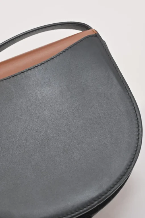 Black and brown leather Heel Duo anagram-embossed shoulder flap bag with adjustable shoulder strap
