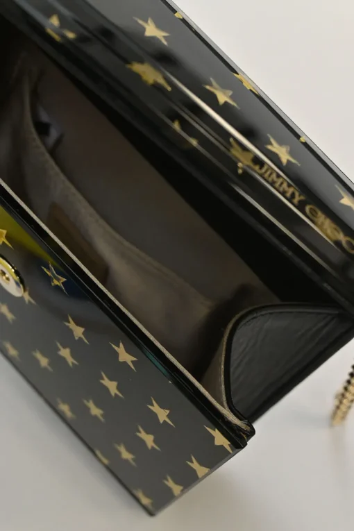 Black and gold acrylic Candy Star clutch with metallic chain strap