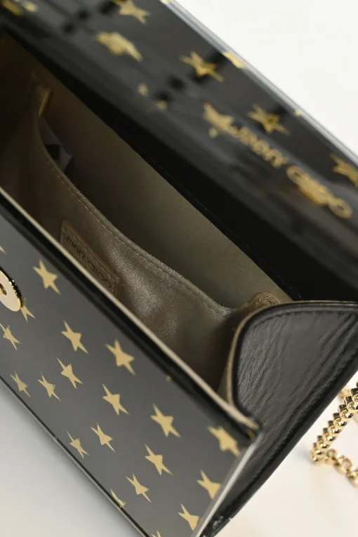Black and gold acrylic Candy Star clutch with metallic chain strap