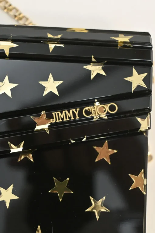Black and gold acrylic Candy Star clutch with metallic chain strap