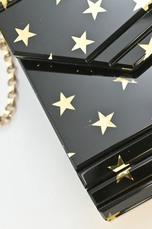 Black and gold acrylic Candy Star clutch with metallic chain strap