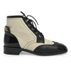 Black and ivory two-tone leather lace-up ankle boots with with patent cap toes