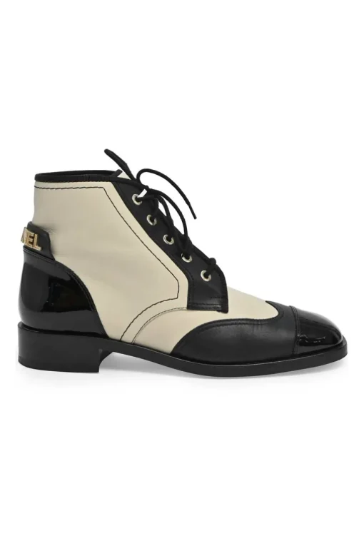 Black and ivory two-tone leather lace-up ankle boots with with patent cap toes