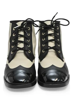 Black and ivory two-tone leather lace-up ankle boots with with patent cap toes