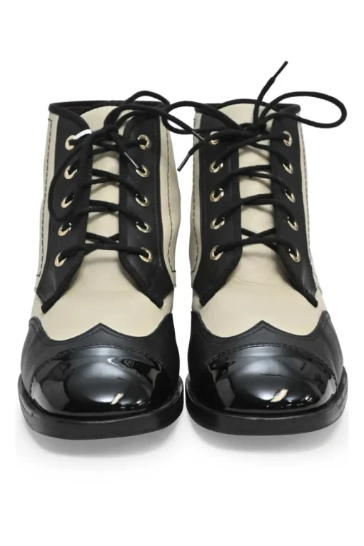 Black and ivory two-tone leather lace-up ankle boots with with patent cap toes