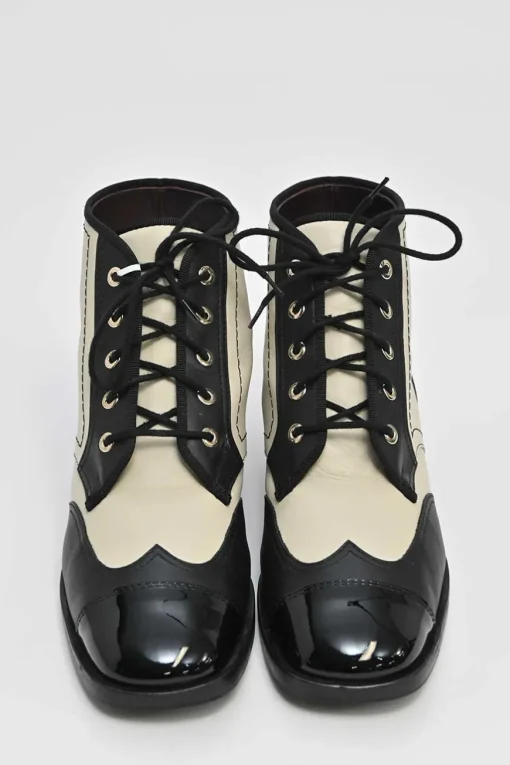 Black and ivory two-tone leather lace-up ankle boots with with patent cap toes