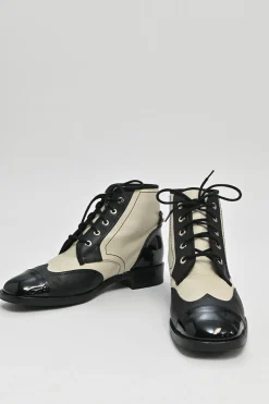 Black and ivory two-tone leather lace-up ankle boots with with patent cap toes