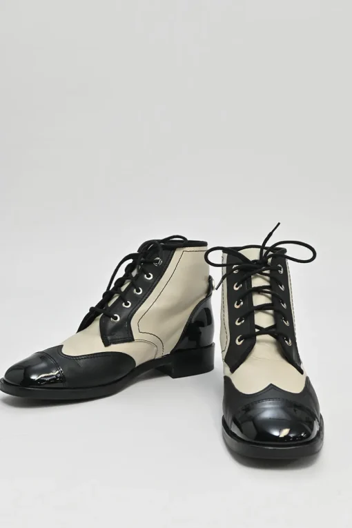 Black and ivory two-tone leather lace-up ankle boots with with patent cap toes