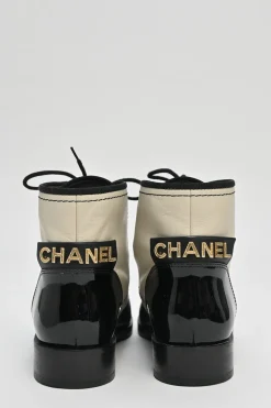 Black and ivory two-tone leather lace-up ankle boots with with patent cap toes