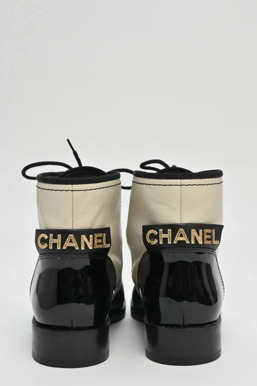 Black and ivory two-tone leather lace-up ankle boots with with patent cap toes