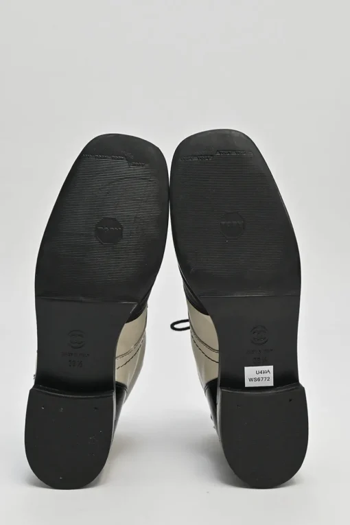Black and ivory two-tone leather lace-up ankle boots with with patent cap toes