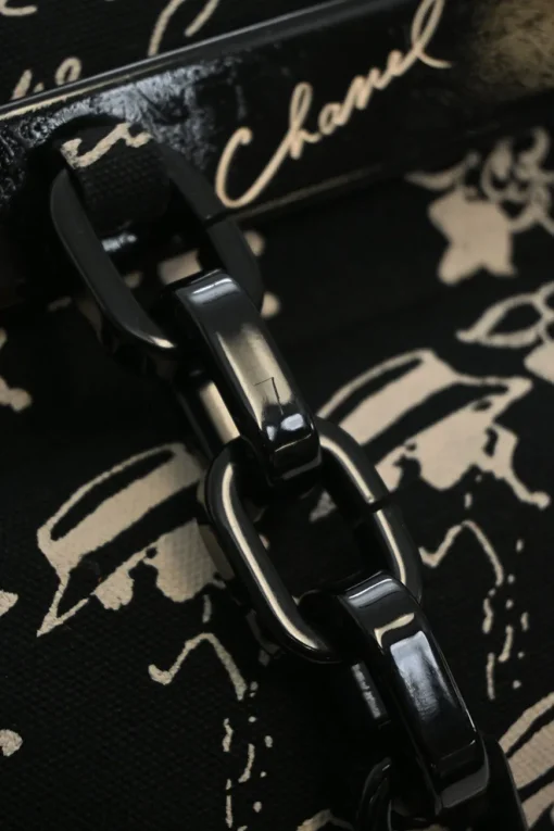 Black and neutral printed canvas and resin chain strap shopper tote featuring house code novelty motif