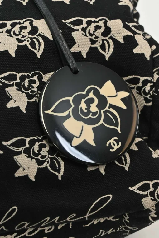 Black and neutral printed canvas and resin chain strap shopper tote featuring house code novelty motif