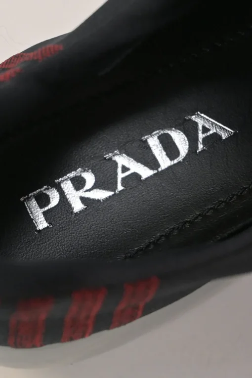Black and red fully-fashioned warp knit and rubber Cloudbust low-top slip-on velcro sneakers
